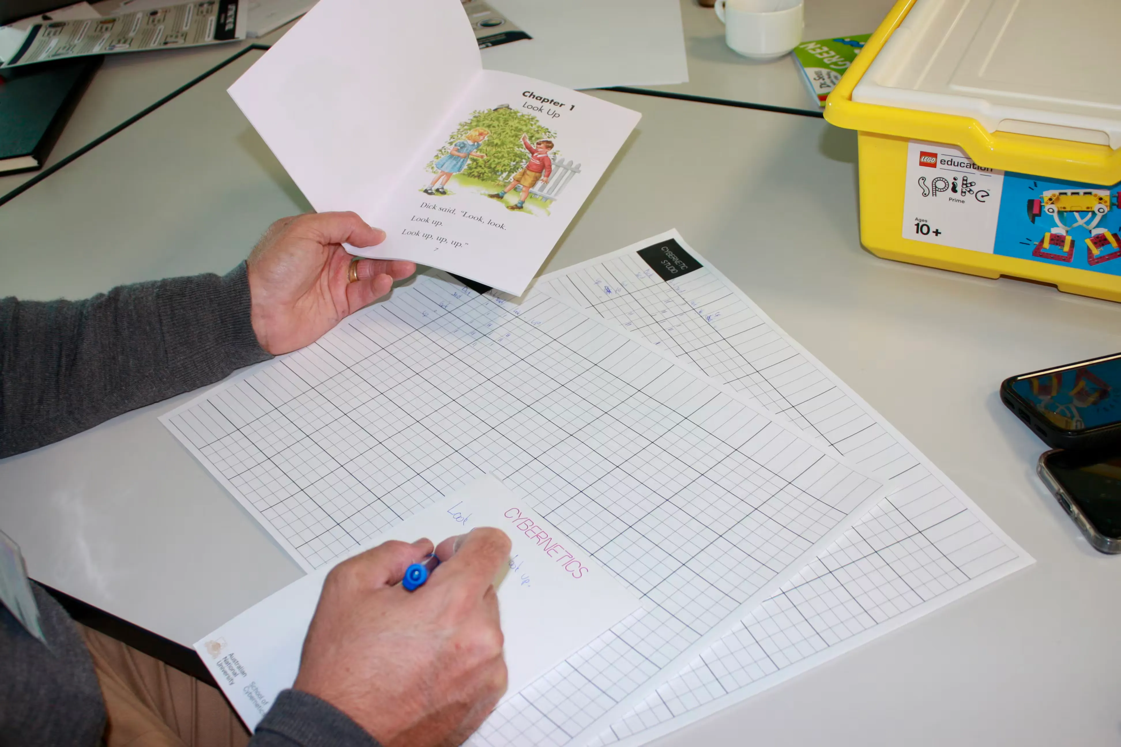 A participant building an N-gram model by hand, tallying token frequencies on a grid worksheet