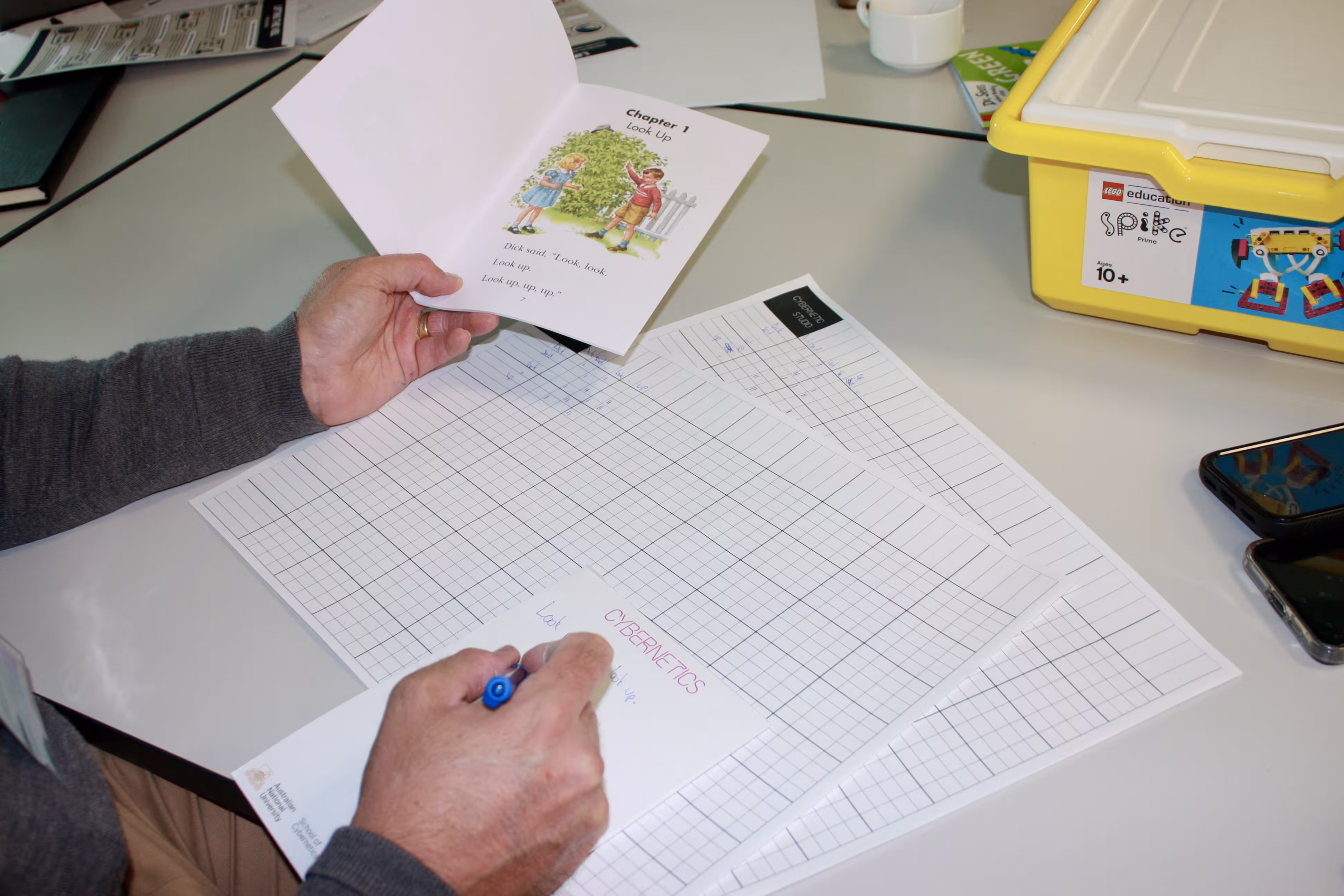 A participant building an N-gram model by hand, tallying token frequencies on a grid worksheet